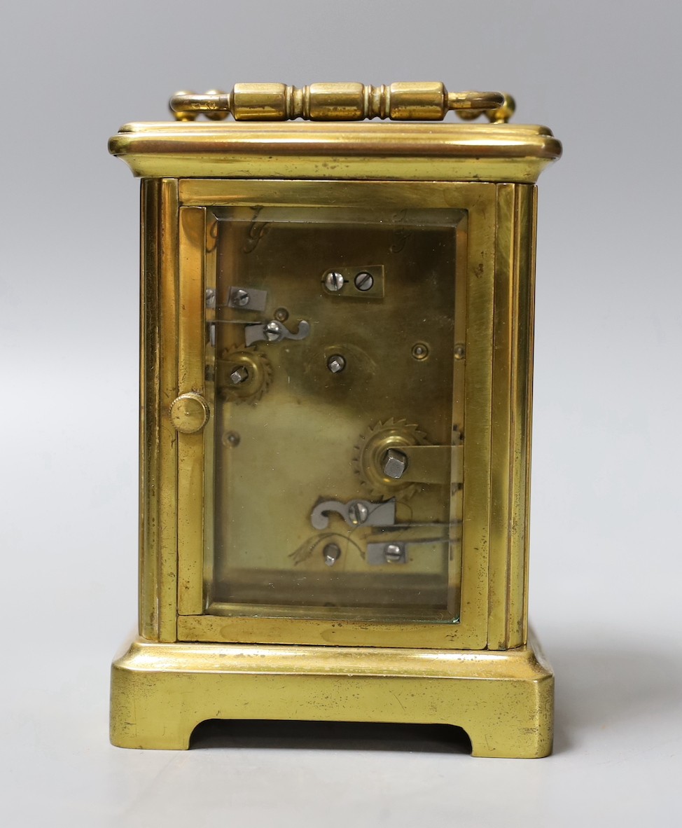 A brass carriage timepiece, retailed by J. Moser & co. in leather case with key.